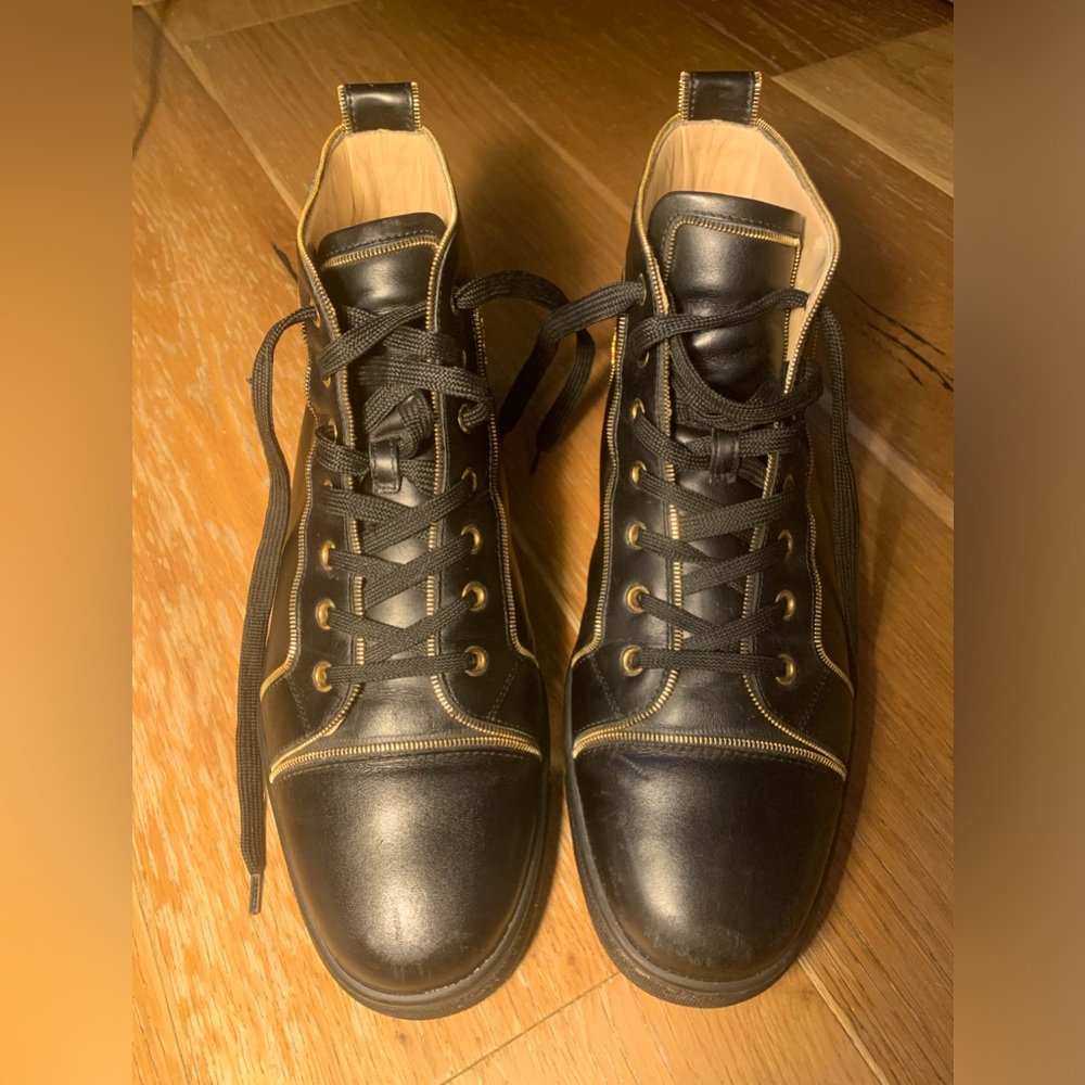 Christian Louboutin black high tops with gold trim. Like new